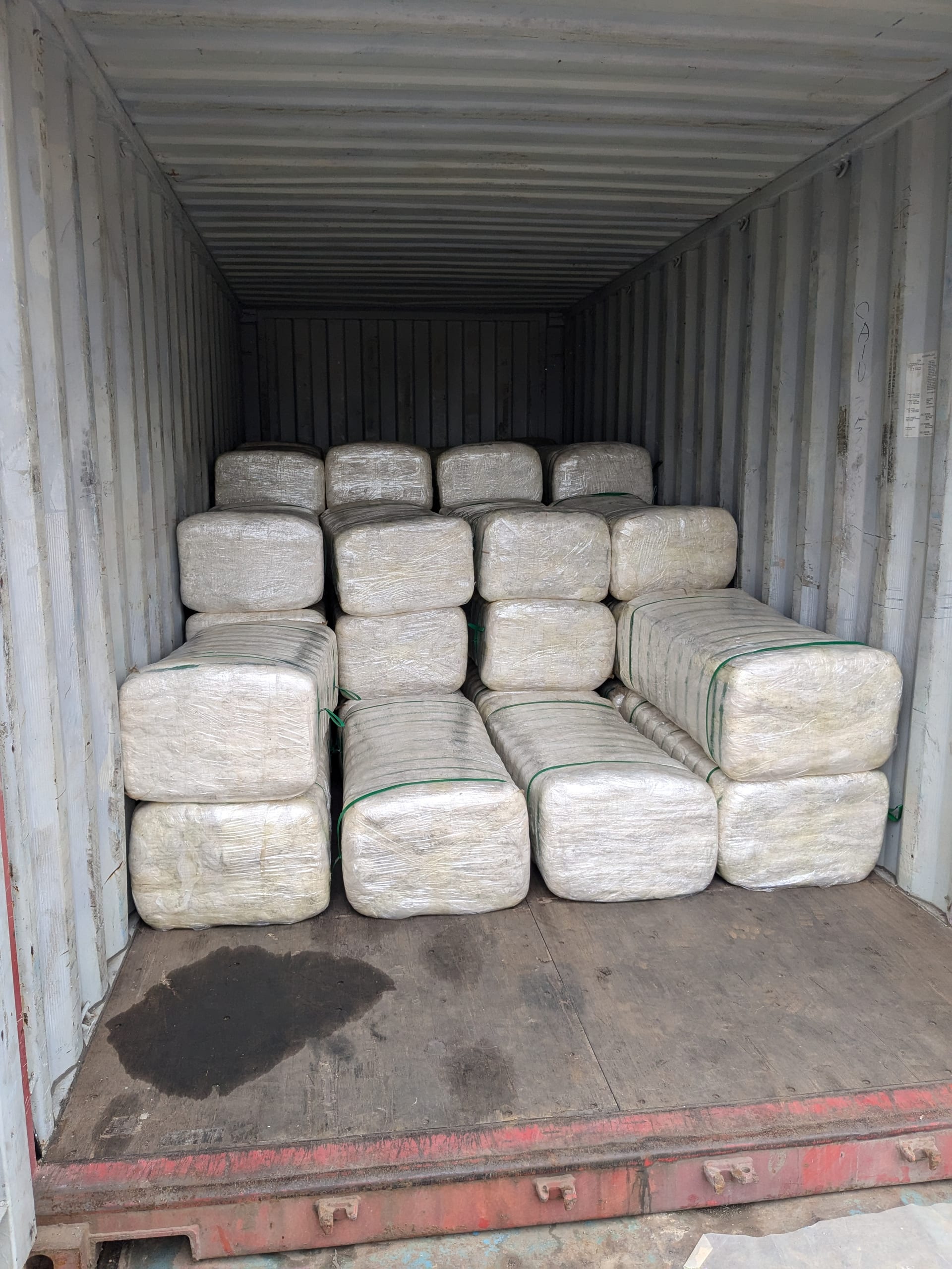 Wrapped bales of pineapple fibre loaded in a shipping container